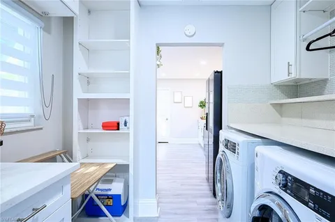a view of storage and utility room with washer and dryer