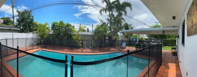 a view of a swimming pool with a patio