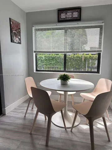 a view of a dining room with furniture window and outside view