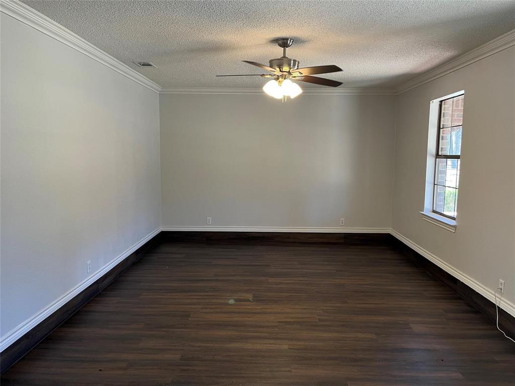9644 Deer Park Road Quinlan, TX 75474 - Photo 11 of 25 a view of an empty room with wooden floor and chandelier