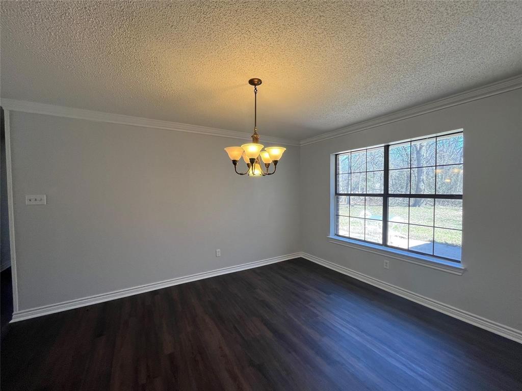 9644 Deer Park Road Quinlan, TX 75474 - Photo 12 of 25 a view of wooden floor chandelier and window in a room