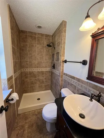 a bathroom with a sink toilet and shower