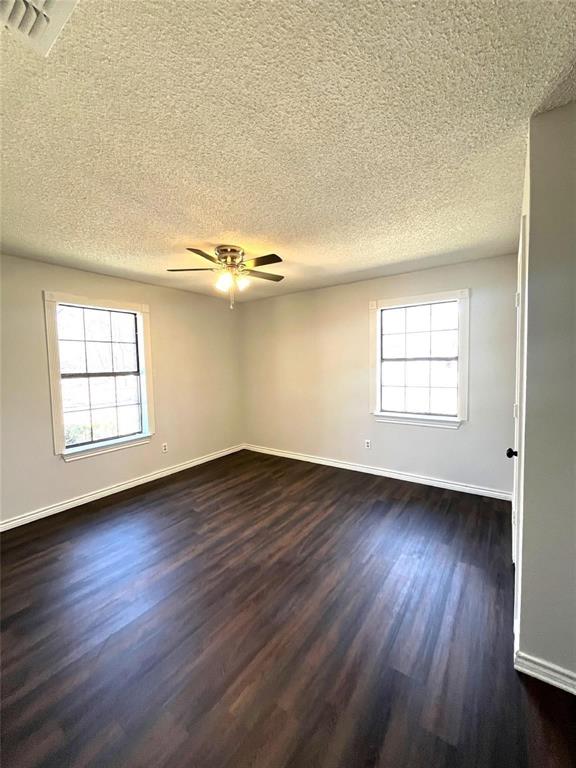 9644 Deer Park Road Quinlan, TX 75474 - Photo 15 of 25 an empty room with wooden floor and windows