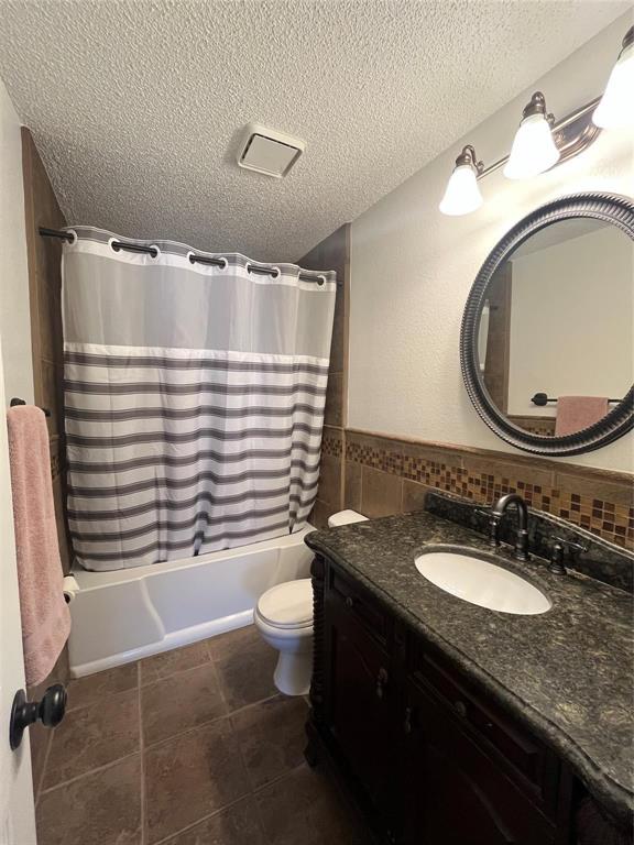 9644 Deer Park Road Quinlan, TX 75474 - Photo 16 of 25 a bathroom with a granite countertop sink toilet and a mirror