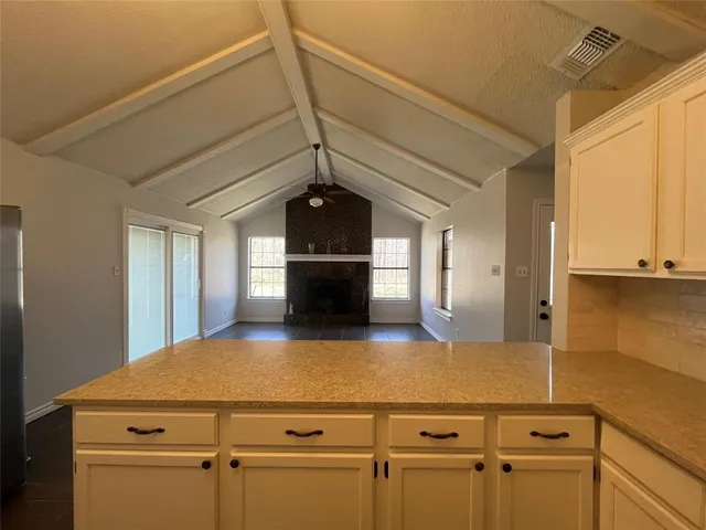 a kitchen with a cabinets and wooden floor