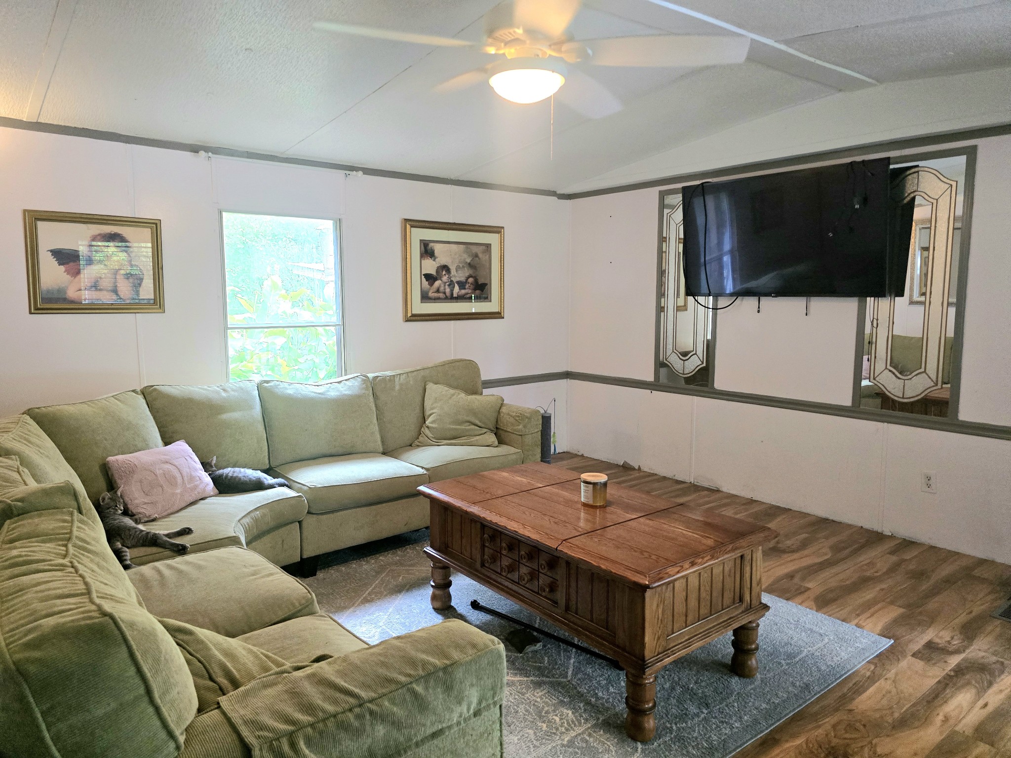 157 Longbranch Road Hohenwald, TN 38462 - Photo 7 of 16 a living room with furniture and a flat screen tv