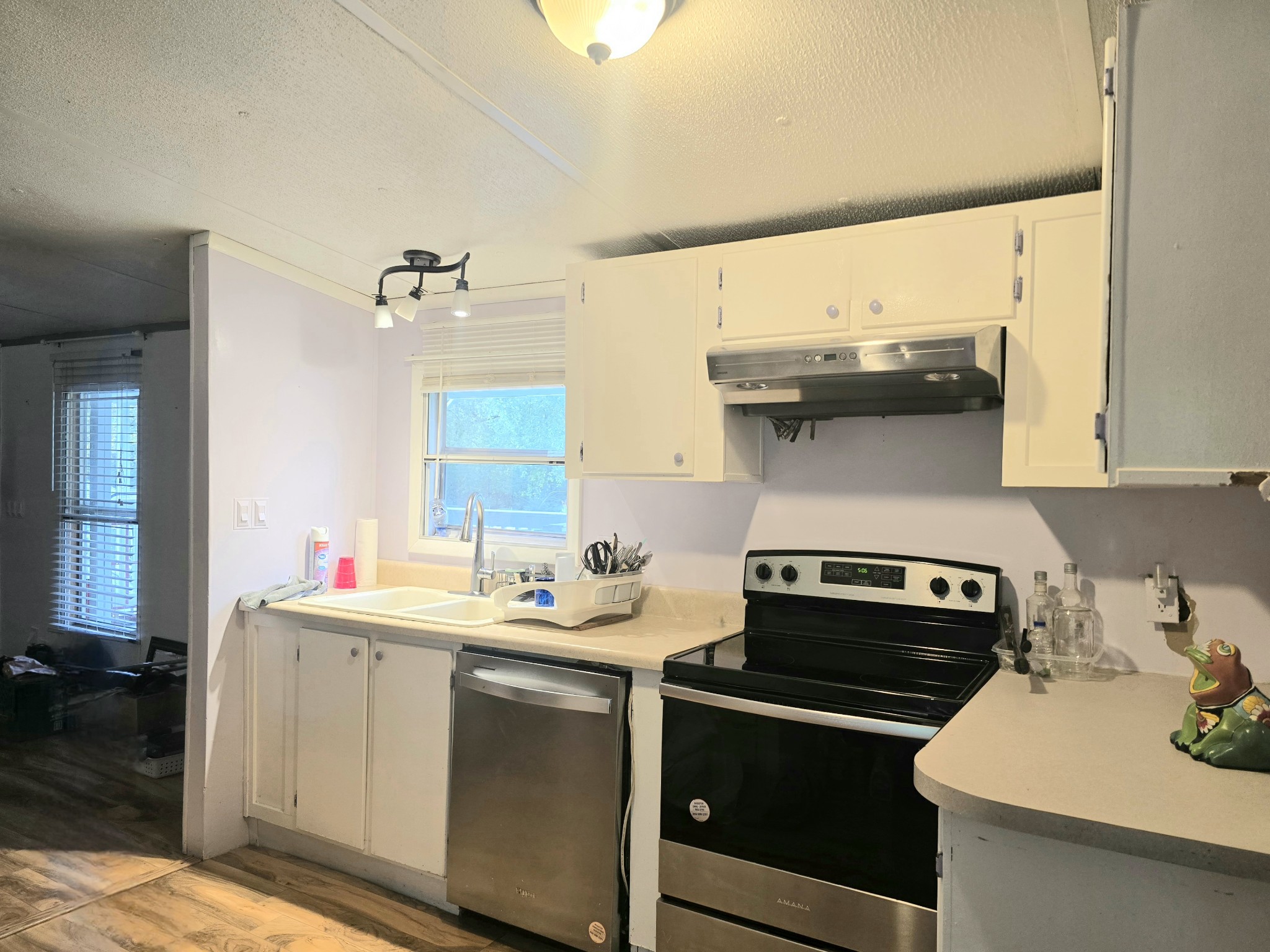 157 Longbranch Road Hohenwald, TN 38462 - Photo 9 of 16 a kitchen with a sink stove and cabinets