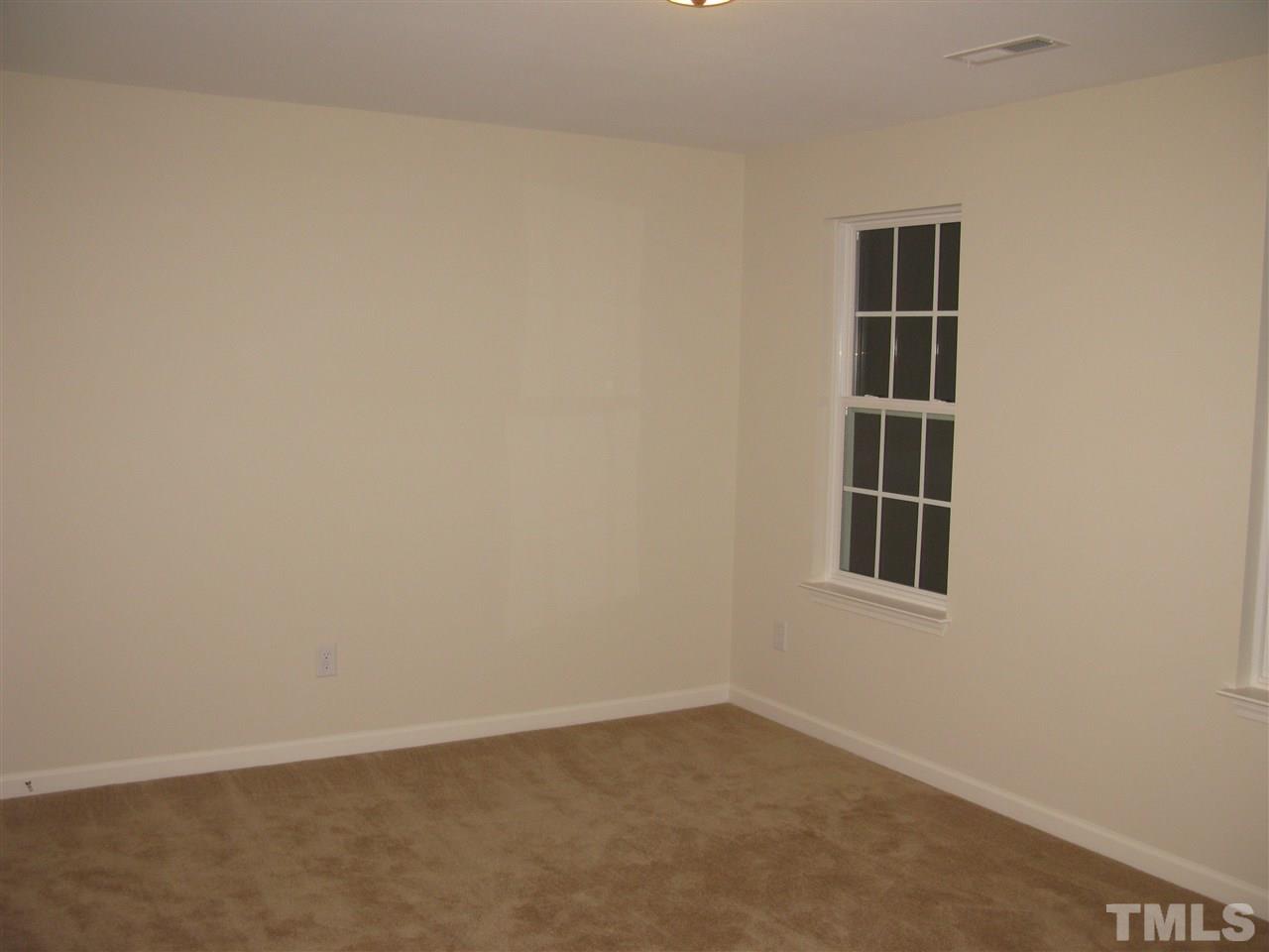 6833 Planting Court Raleigh, NC 27610 - Photo 14 of 18 an empty room with a window
