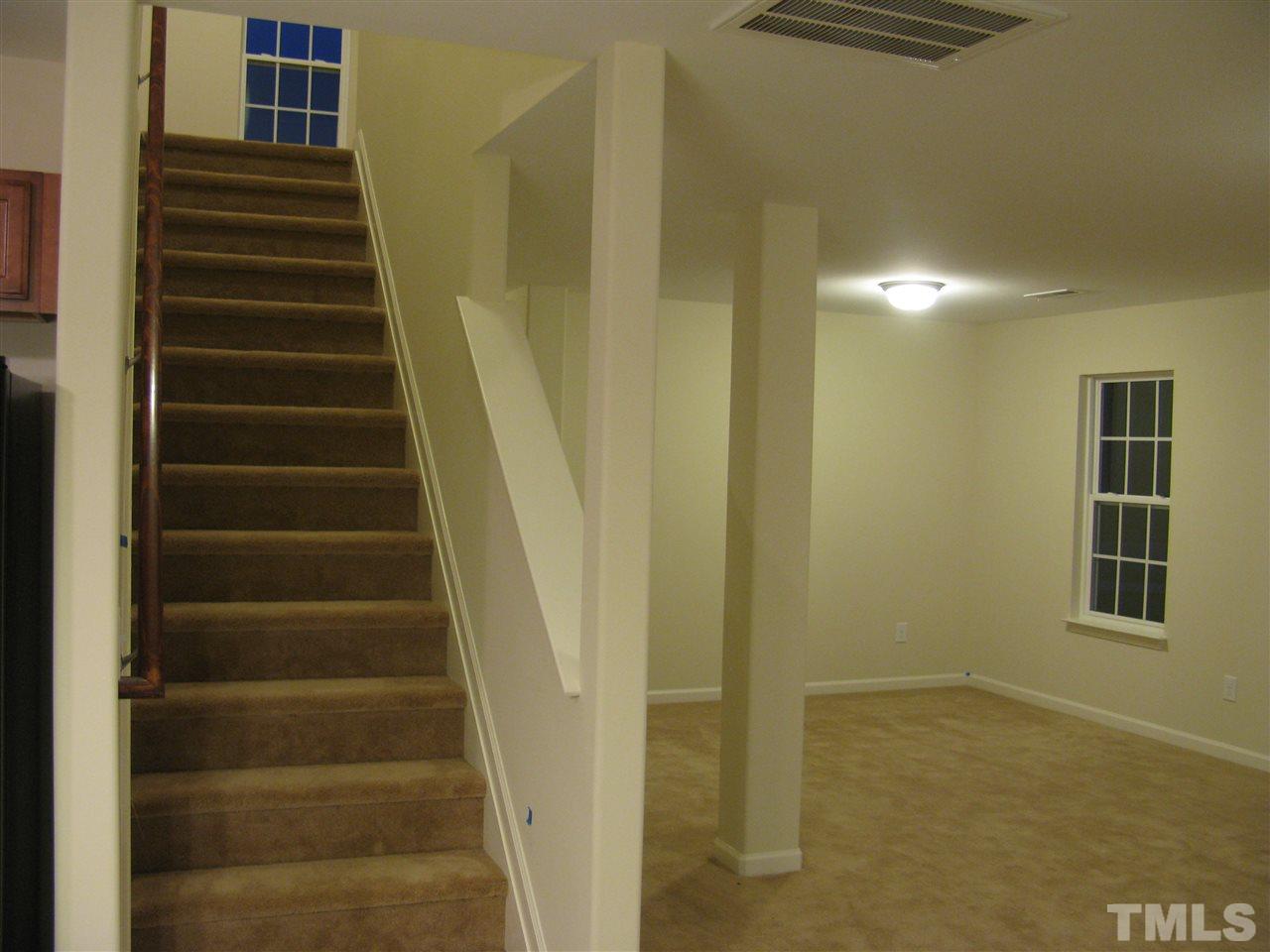 6833 Planting Court Raleigh, NC 27610 - Photo 17 of 18 a view of entryway with wooden floor and windows