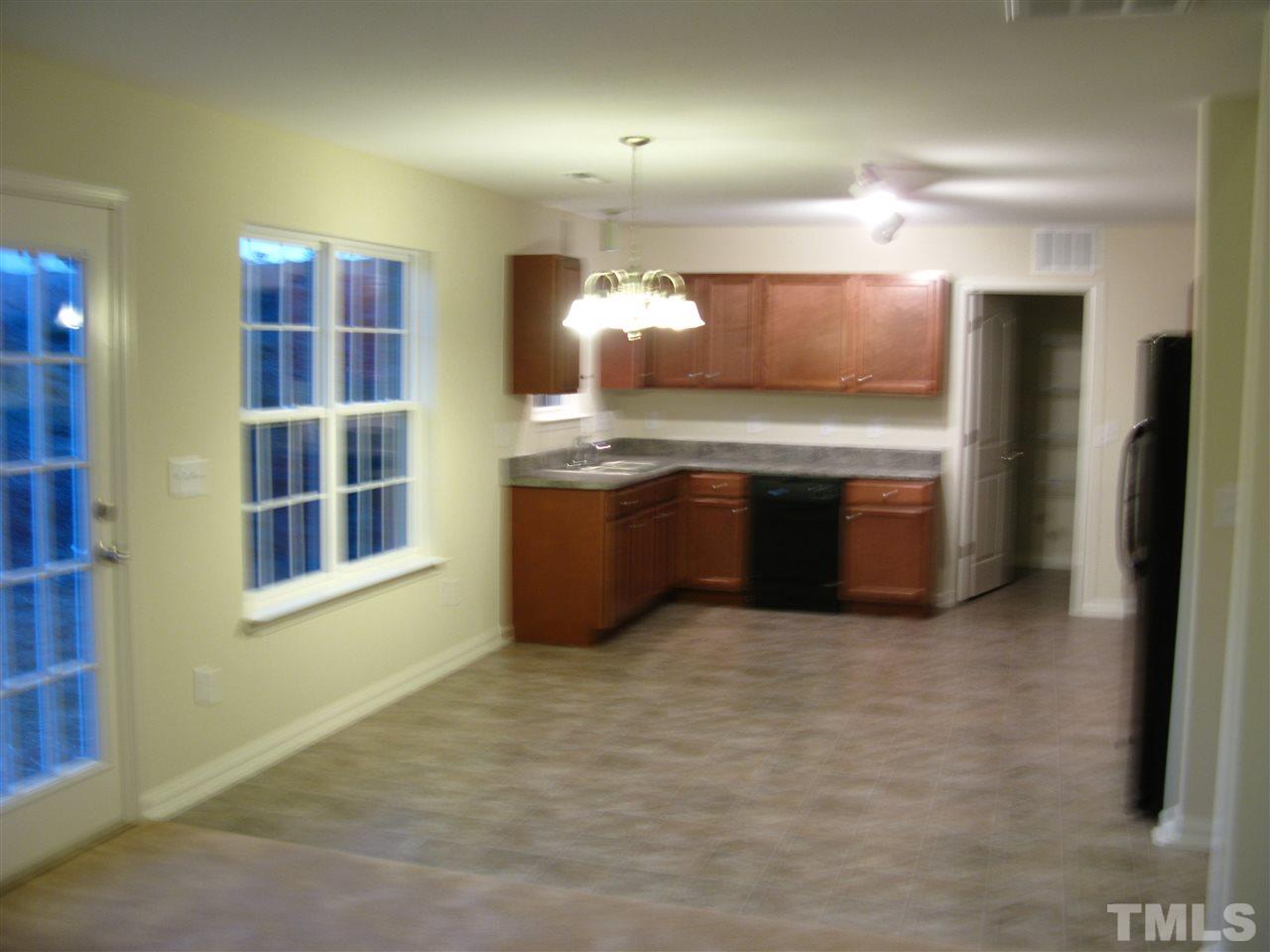 6833 Planting Court Raleigh, NC 27610 - Photo 3 of 18 a view of kitchen with granite countertop cabinets and refrigerator