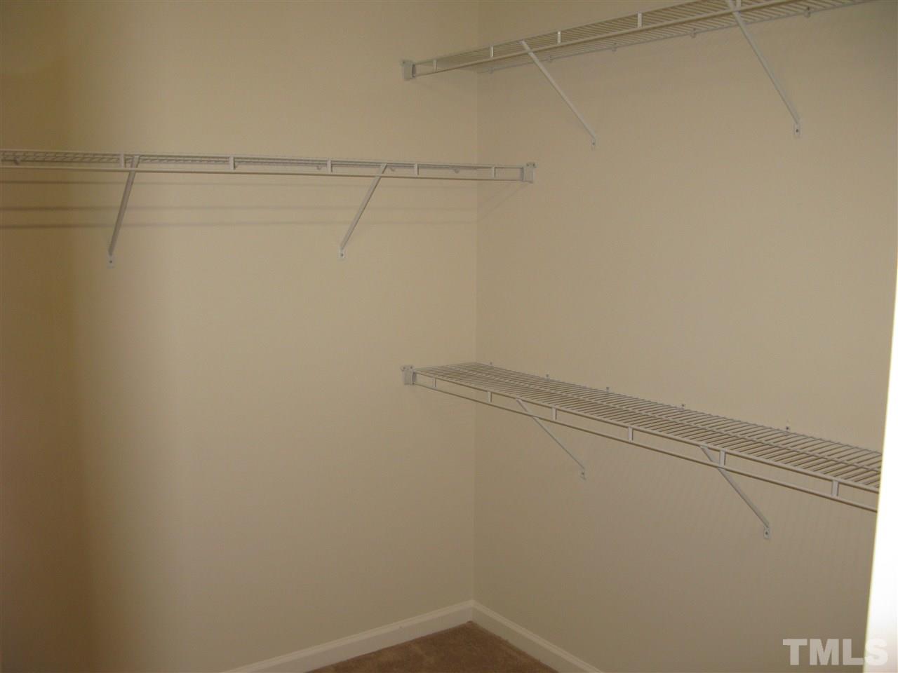 6833 Planting Court Raleigh, NC 27610 - Photo 10 of 18 a view of a room with racks on the wall