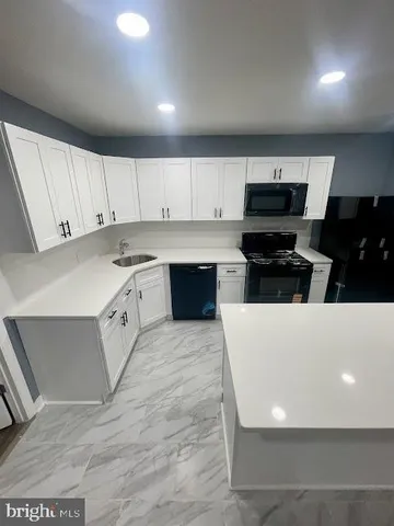 a large kitchen with cabinets