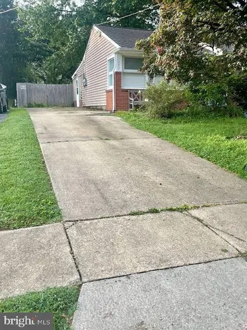 a view of backyard of house with green space