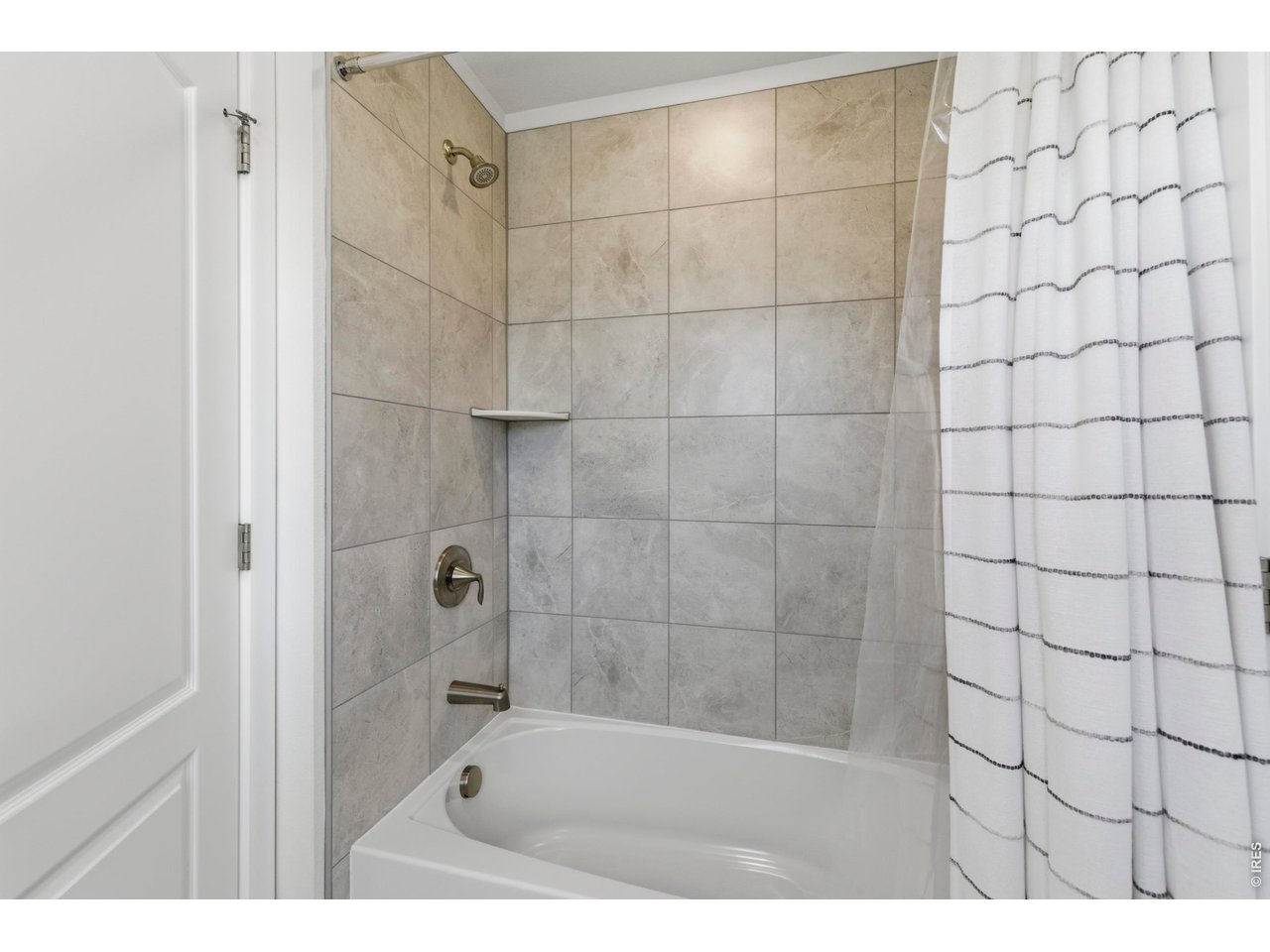 2910 Water View Street Timnath, CO 80547 - Photo 32 of 50 a bathroom with a shower and a bath tub
