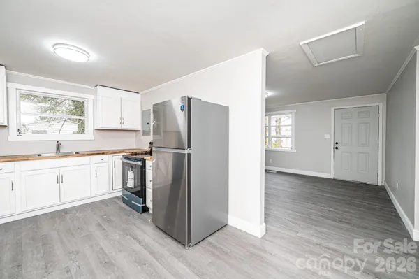 a kitchen with a refrigerator and a sink