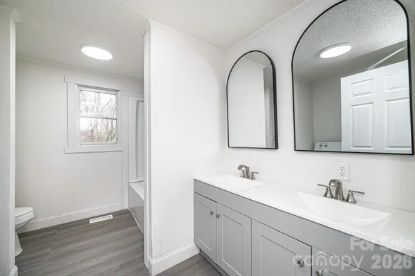 a bathroom with a granite countertop sink a mirror and vanity