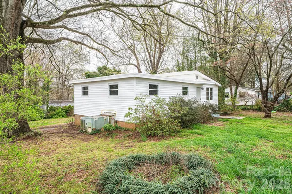 a white house that has a tree in front of it