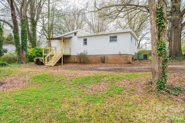 a backyard of a house with table and chairs