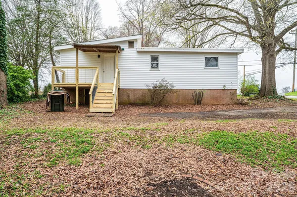 a view of a small house with roof deck
