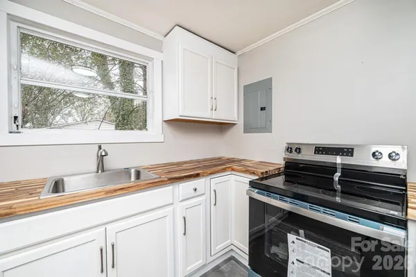 a kitchen with a sink stove and cabinets