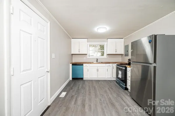 a kitchen with a refrigerator a sink and cabinets