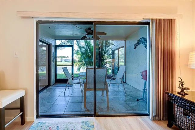 a view of a porch with a dining table and chairs
