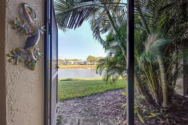 a dining room with furniture and a floor to ceiling window