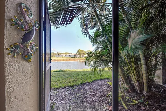 a dining room with furniture and a floor to ceiling window