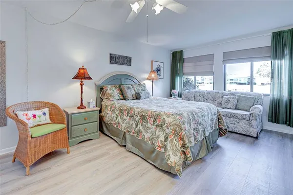 a bedroom with a large bed and a large window