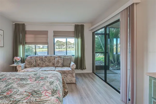 a dining room with furniture a chandelier and wooden floor