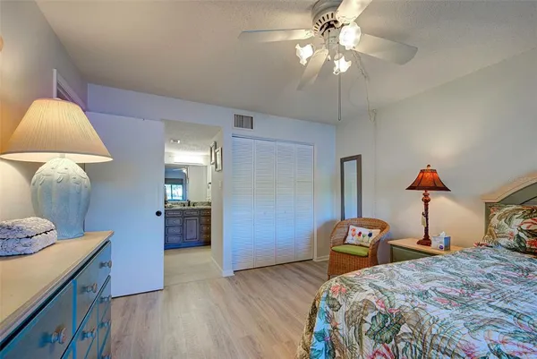 a bathroom with a granite countertop sink mirror and cabinets