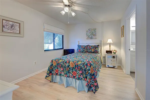 a bedroom with bed and mirror