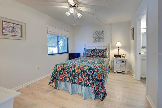 a bedroom with bed and mirror