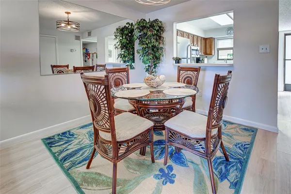 a dining room with furniture and wooden floor