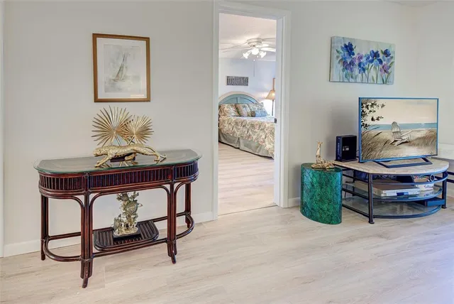 a living room with furniture and paintings on the wall
