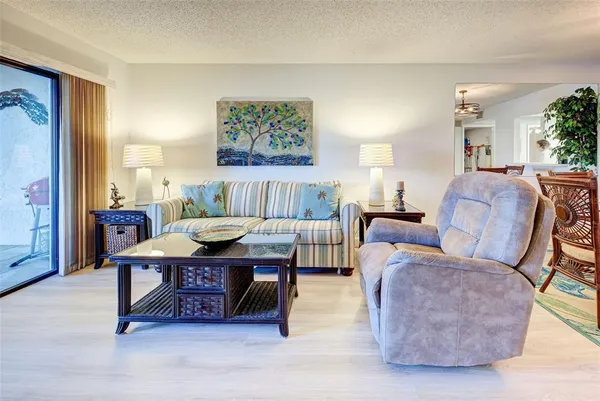 a living room with furniture and a painting