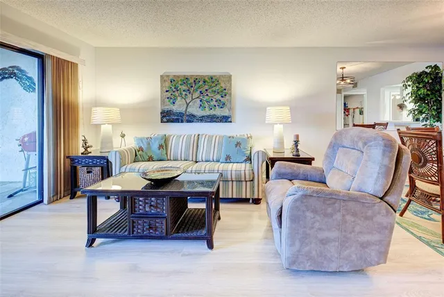 a living room with furniture and a painting