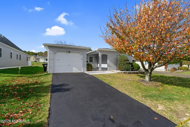 a front view of house with yard and green space
