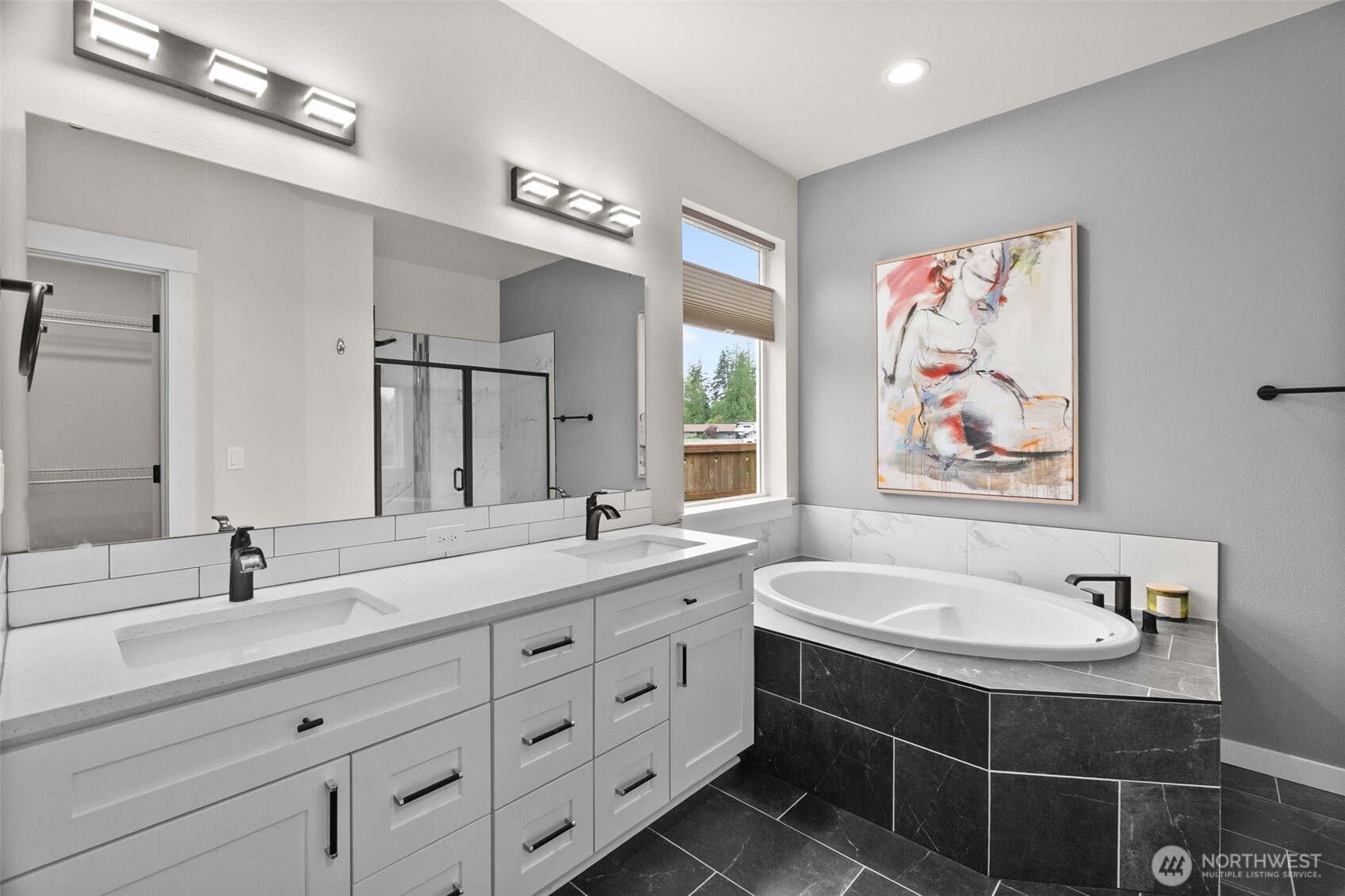 32 Coyote Road Montesano, WA 98563 - Photo 18 of 37 a bathroom with a double vanity sink a mirror a bathtub and a window