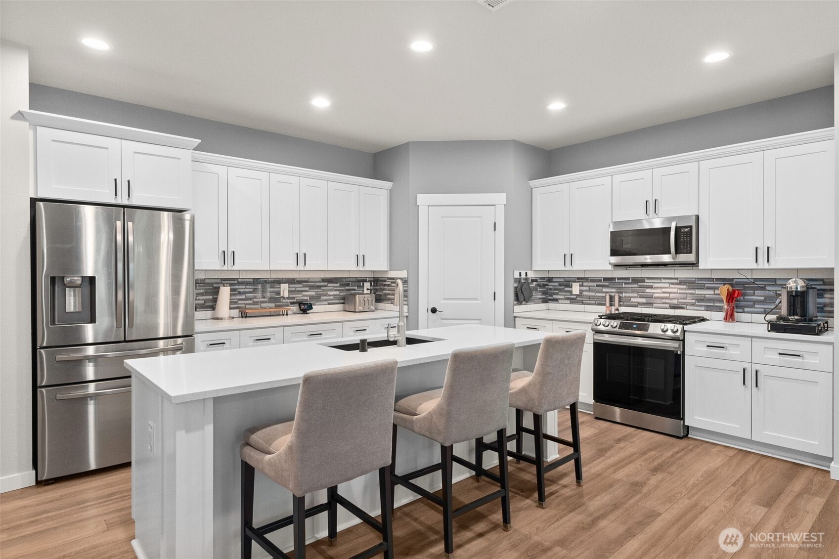 32 Coyote Road Montesano, WA 98563 - Photo 8 of 37 a kitchen with white cabinets stainless steel appliances and a refrigerator