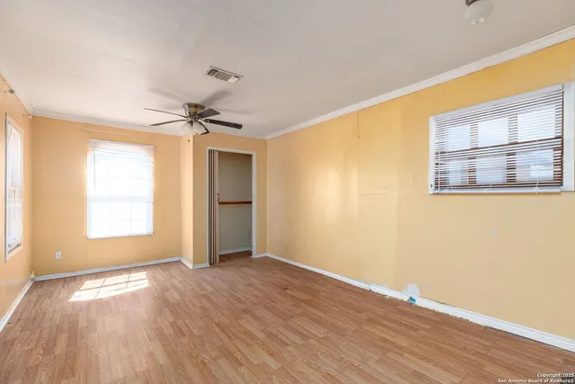 wooden floor in an empty room with a window