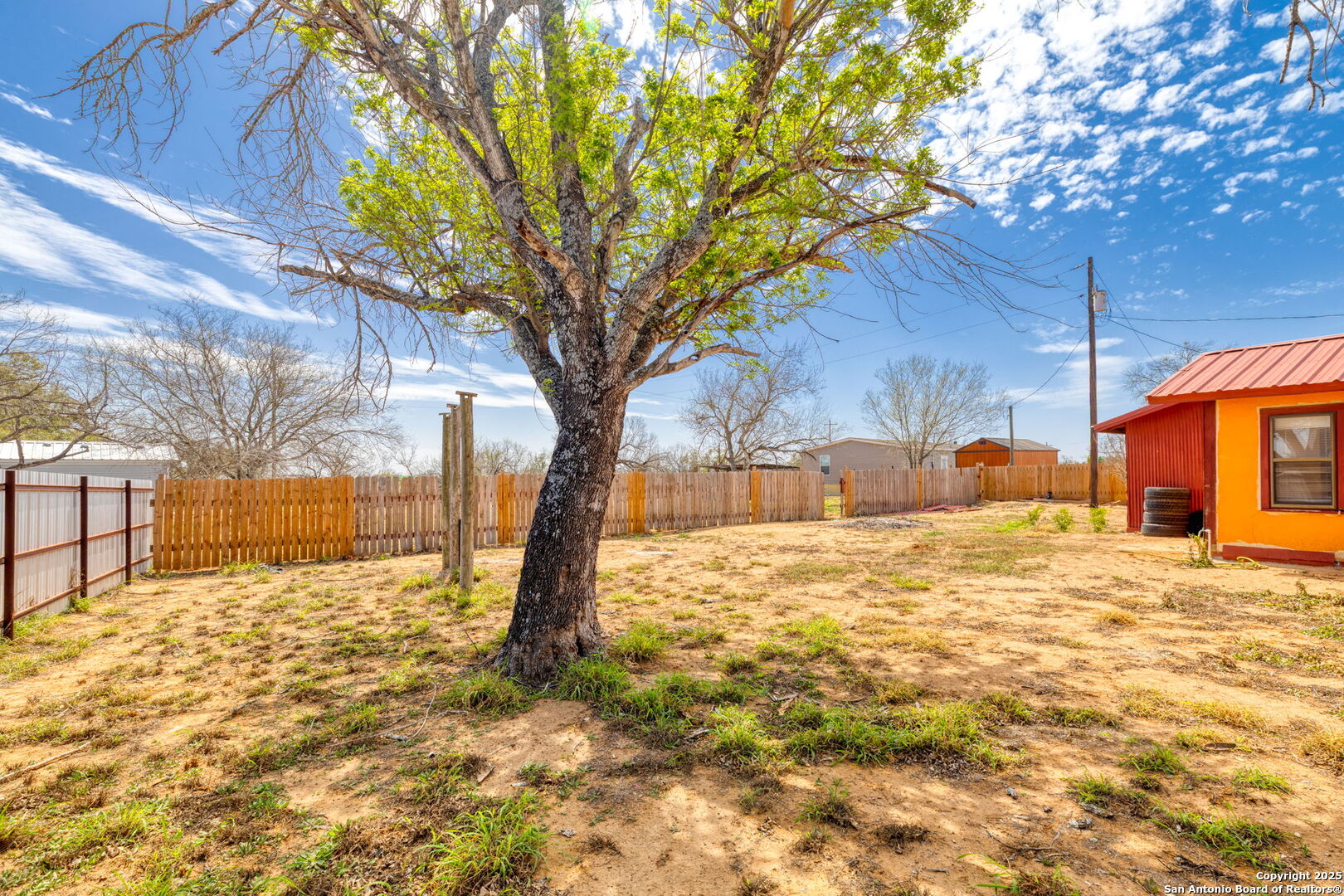 13934 Interstate 35 Moore, TX 78057 - Photo 23 of 29 a tree in the middle of a yard
