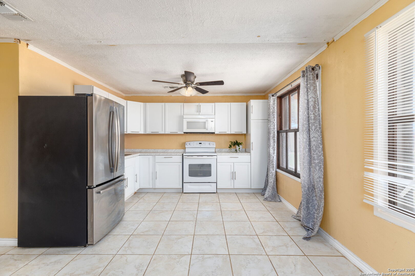 13934 Interstate 35 Moore, TX 78057 - Photo 5 of 29 a kitchen with a refrigerator a sink and cabinets