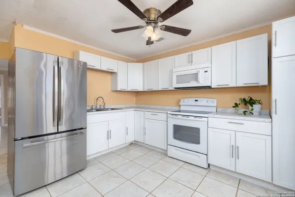 a kitchen with cabinets stainless steel appliances and a counter space