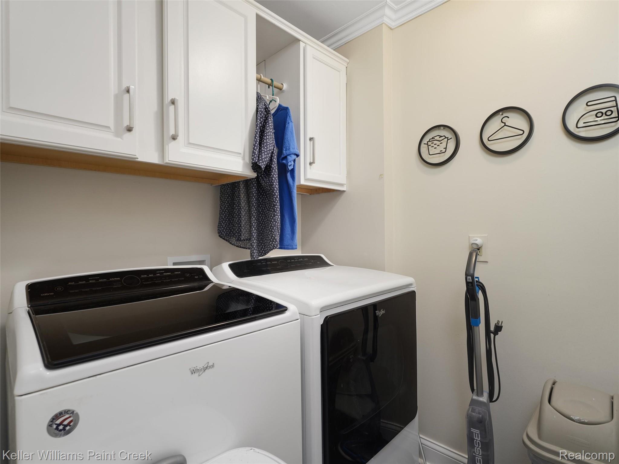5813 36 Mile Road Romeo, MI 48065 - Photo 27 of 81 Laundry area featuring white cabinetry, a built-in hanging rod, crown molding, and light-toned walls
