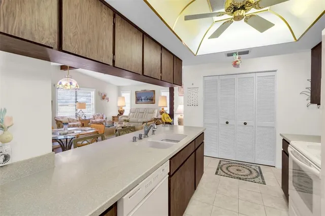 a kitchen with a table chairs refrigerator and microwave