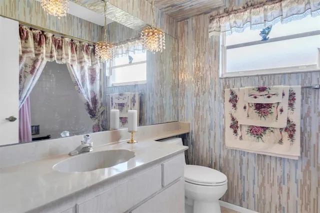 a bedroom with a bed and a tv on the dresser