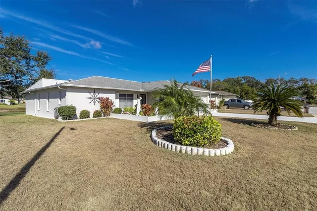 an aerial view of a house with outdoor space and a lake view