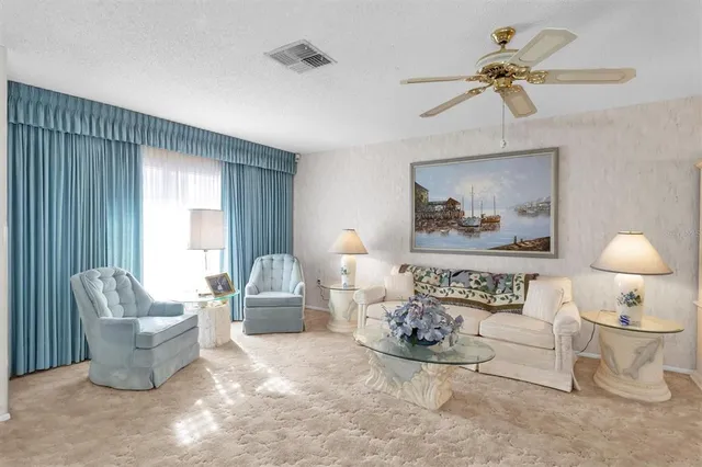 a bedroom with furniture and a large window