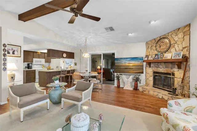 a living room with furniture kitchen view and a fireplace
